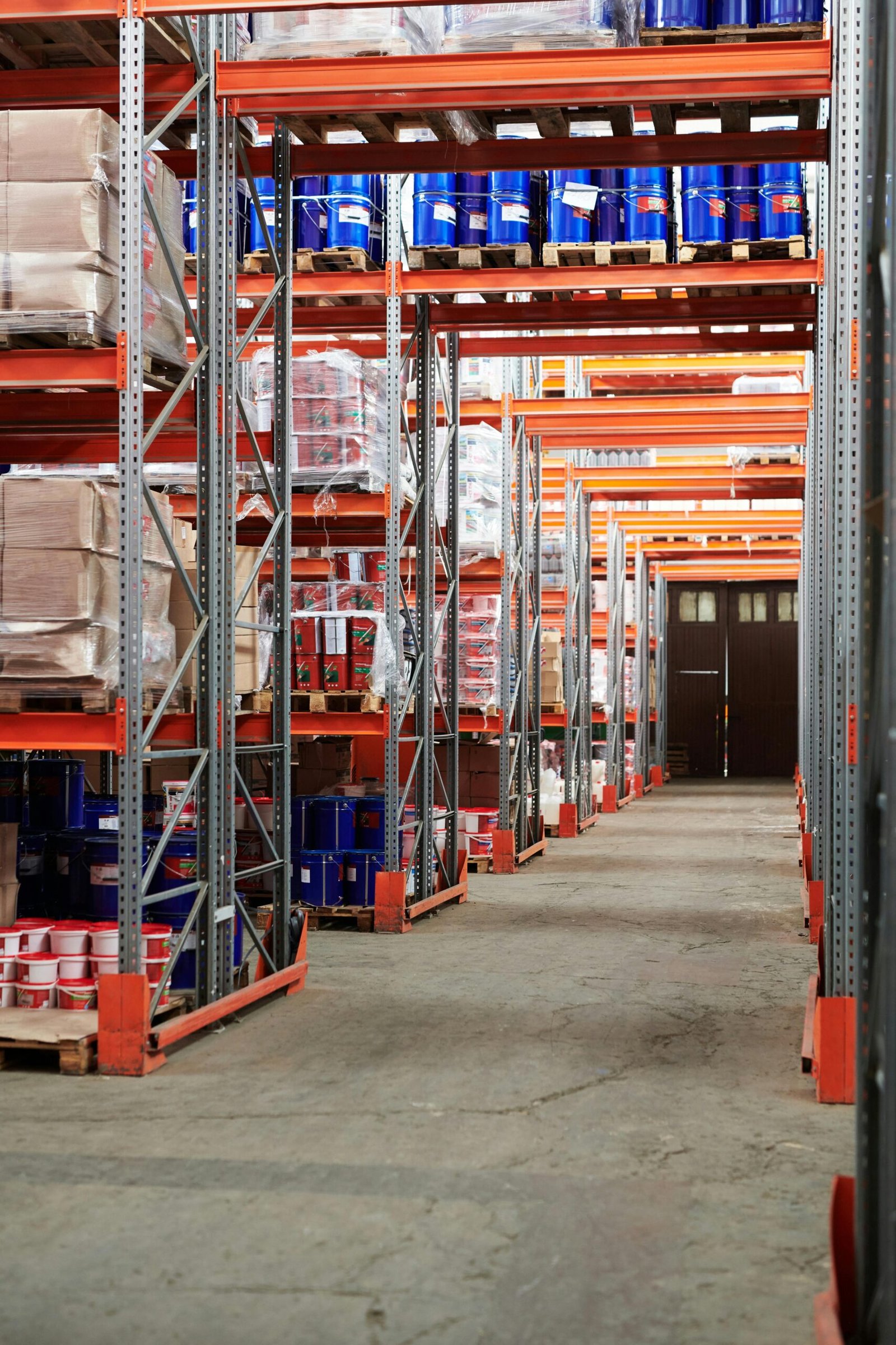 Industrial warehouse interior with organized shelves stacked with packages and goods.