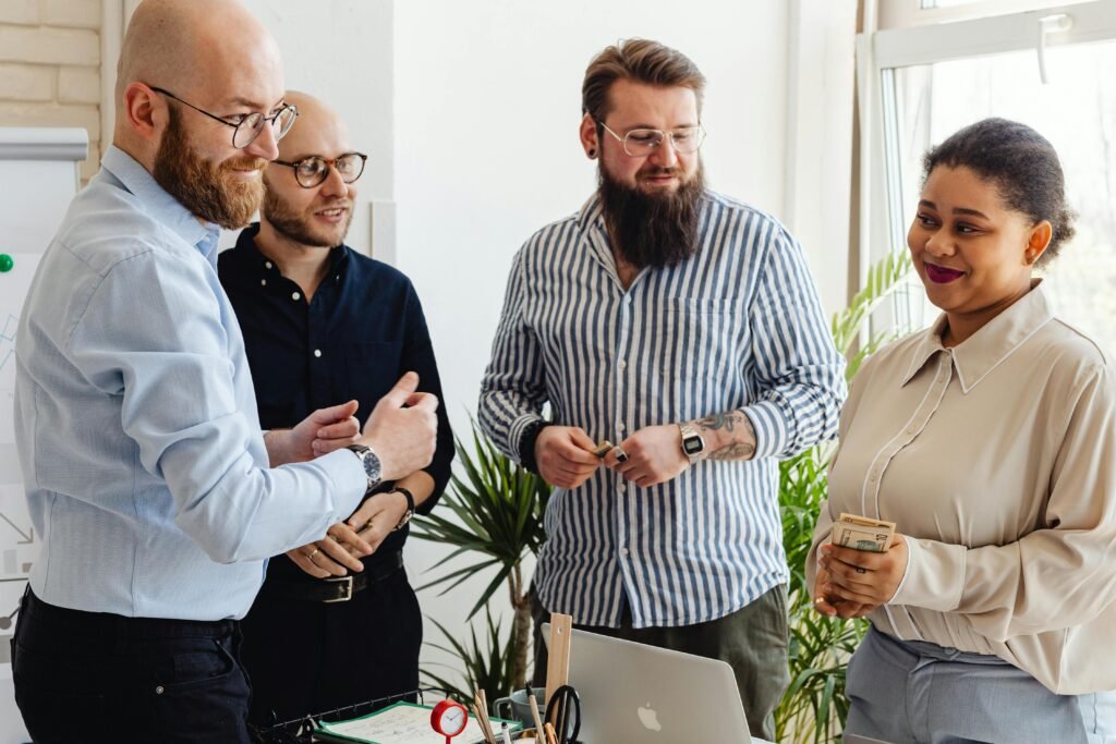 Colleagues sharing ideas and smiling during a team meeting in a modern office.